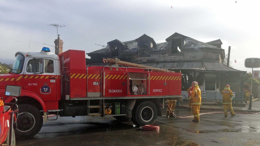 A fire crew outside the burnt out historic Campania Tavern in southern Tasmania