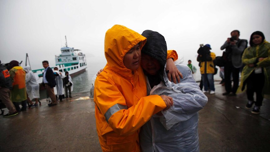 Family members grieve missing South Korean ferry passengers.