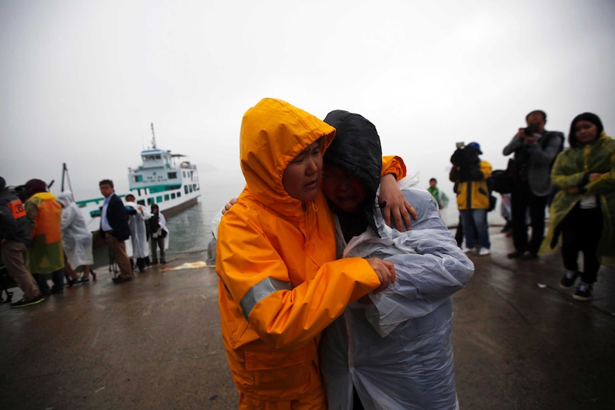 Family members grieve missing South Korean ferry passengers.