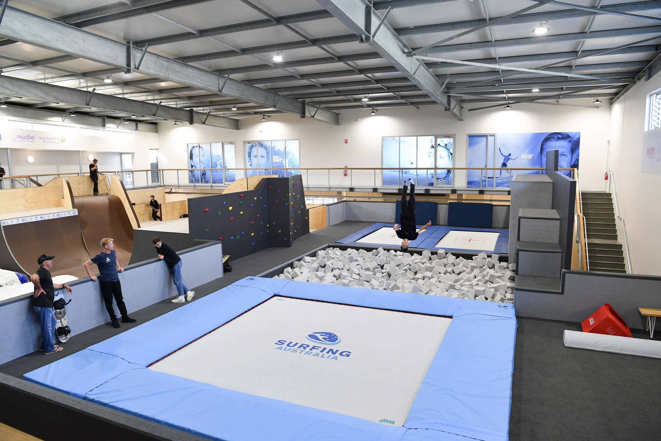 a girl boucing on a trampoline with a board attached to her feet