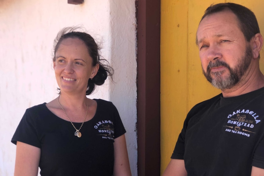 Belinda Turner and Brian Snelson outside the Oakabella Homestead, with a yellow door.