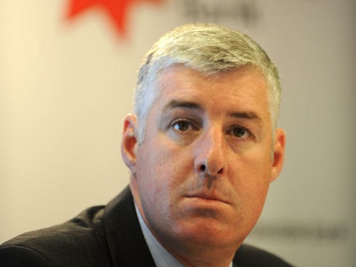 National Australia Bank CEO Cameron Clyne with logo behind him.