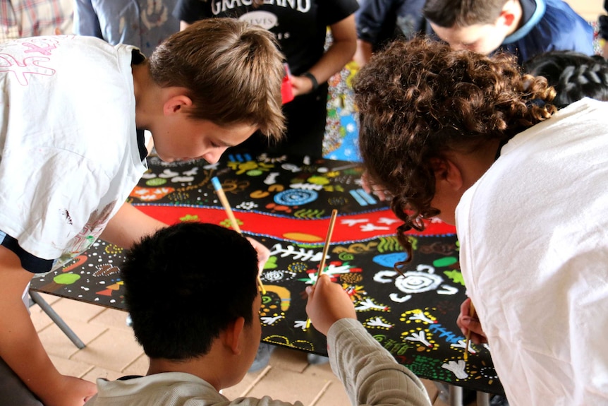 Children working on a canvas