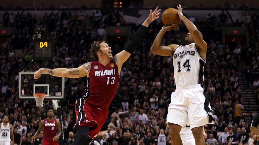 Gary Neal of San Antonio makes a three-pointer over Miami's Mike Miller in NBA Finals game three.