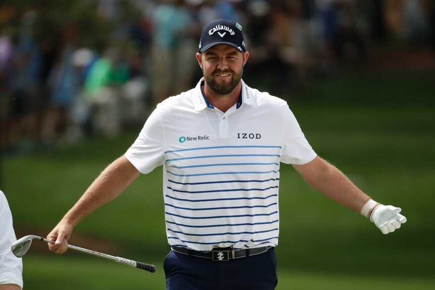Australian golfer Marc Leishman spreads arms wide to celebrate his chip shot