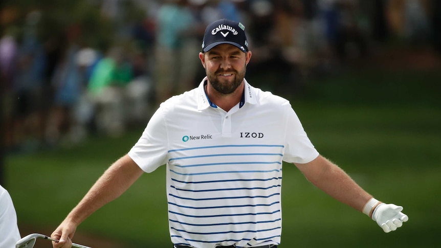 Australian golfer Marc Leishman spreads arms wide to celebrate his chip shot