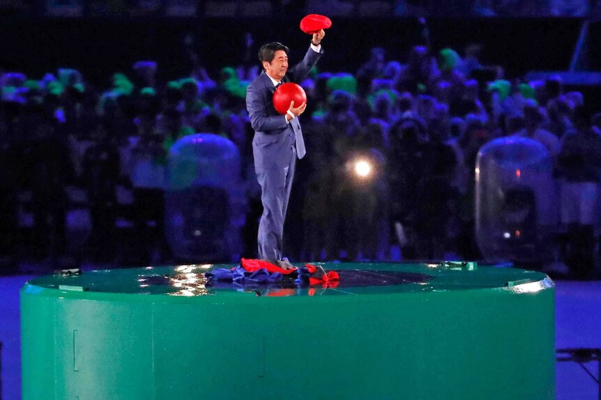 Japan's Prime Minister Shinzo Abe waves during the Olympics closing ceremony on August 22, 2016.