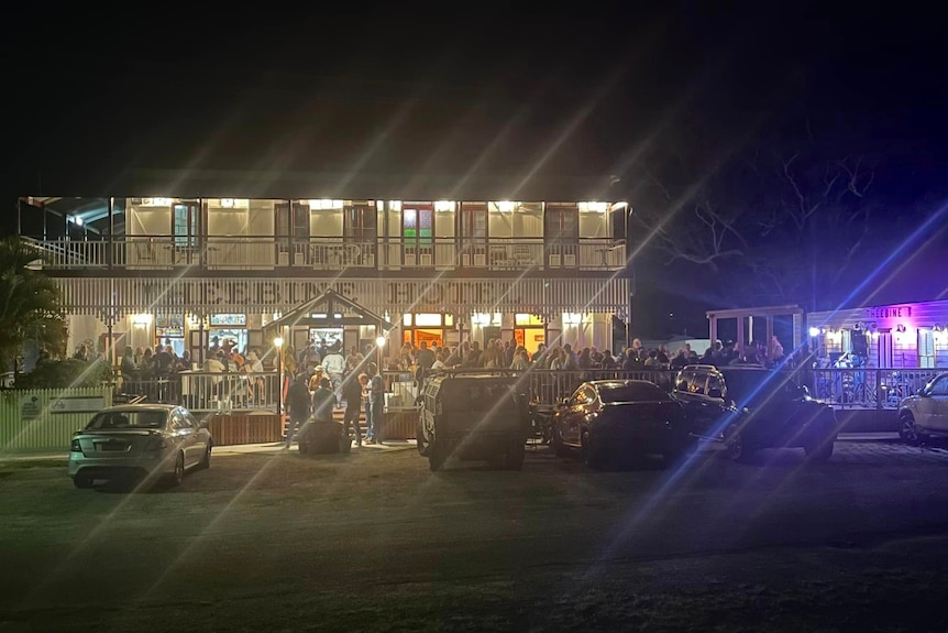 A photo of the pub at night, you can see how crowded it is.