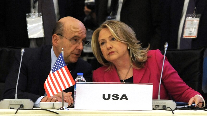 US secretary of state Hillary Clinton (right) listens to French foreign minister Alain Juppe at Friends of Syria conference.