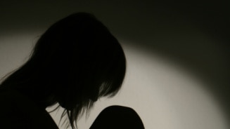 Silhouette of woman looking depressed (Getty Images: Thinkstock)