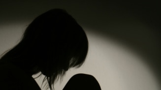 Silhouette of woman on chair (Thinkstock)