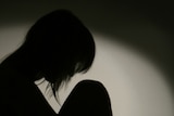 Silhouette of woman on chair (Thinkstock)