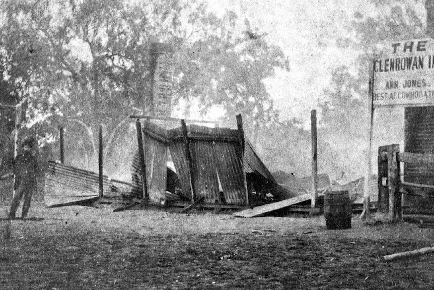 A black-and-white photograph of a country pub that was destroyed by fire.