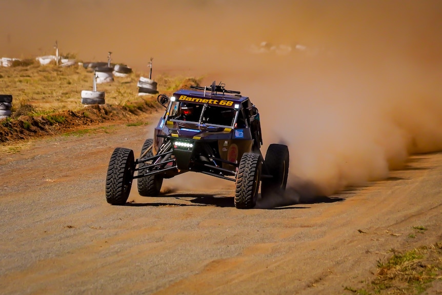 A dune buggy tearing through the desert.