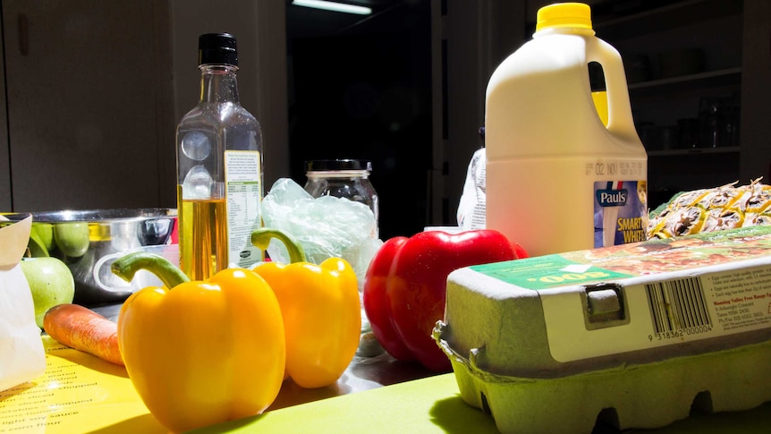 Food ingredients sit on a kitchen bench.