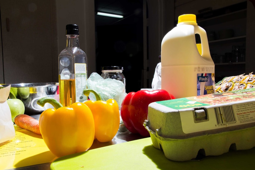 Food ingredients sit on a kitchen bench.