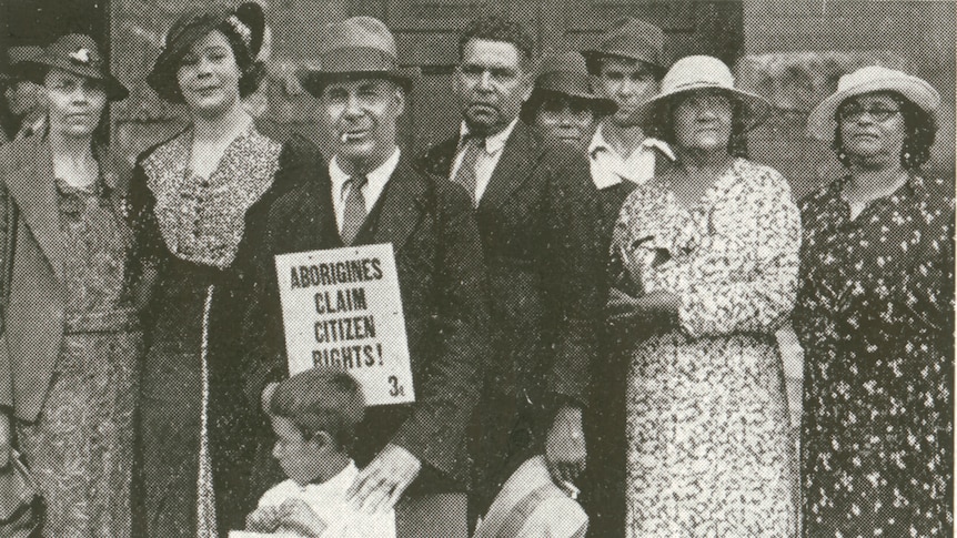 A black and white photo of Aboriginal men and women in 1938, holding a sign that reads "Aborigines claim citizen rights!"