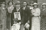 A black and white photo of Aboriginal men and women in 1938, holding a sign that reads "Aborigines claim citizen rights!"