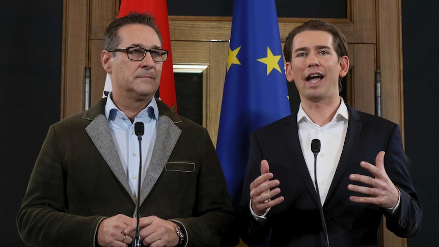 Heinz-Christian Strache of the right-wing Freedom Party stands beside Austrian People's Party leader Sebastian Kurz.