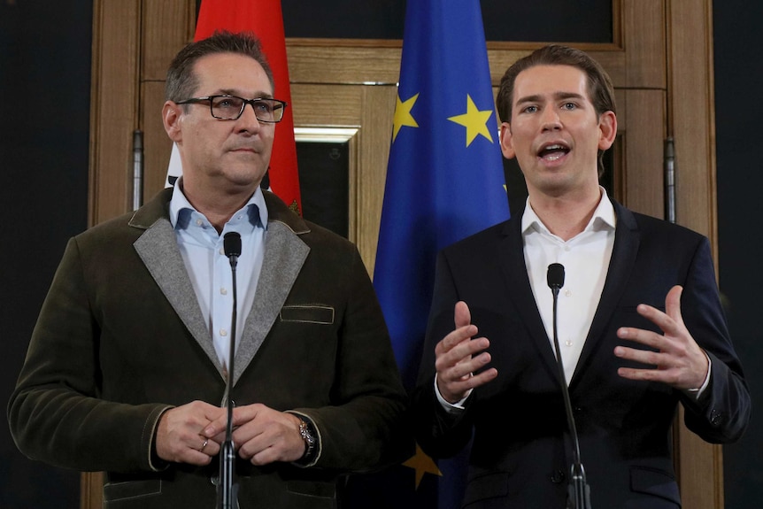 Heinz-Christian Strache of the right-wing Freedom Party stands beside Austrian People's Party leader Sebastian Kurz.