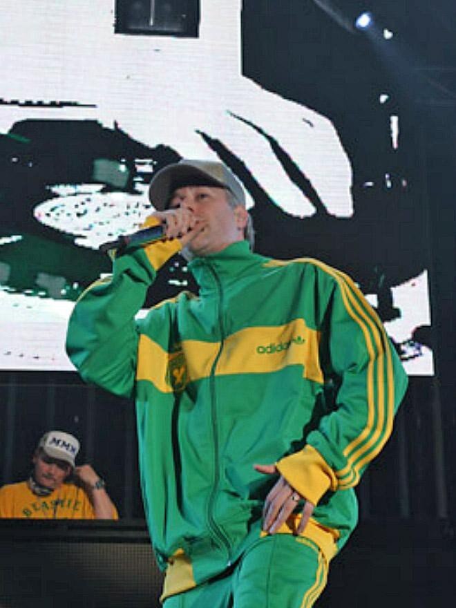 Beastie Boys' MCA raps on stage at the Big Day Out in Sydney in 2005 wearing a green and gold Adidas tracksuit