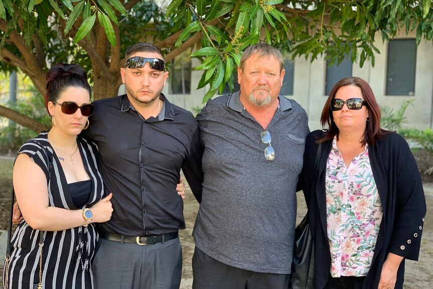 Four members of McCabe family stand together outside a court in Townsville.
