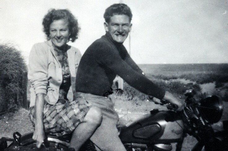 a couple on a motorbike with no helmets
