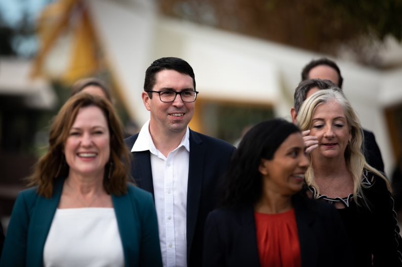 Patrick Gorman smiling as he walks alongside his Labor colleagues 