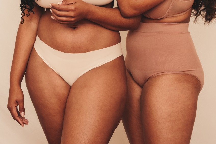 two women standing together in their underwear