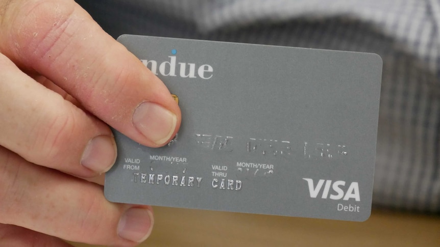 Person holds a blurred cashless card