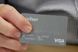 Person holds a blurred bank card