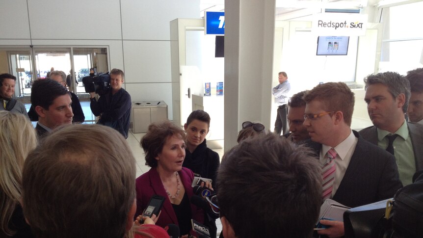 SA Opposition Leader Isobel Redmond surrounded by reporters at Adelaide Airport responding to speculation, August 14 2012