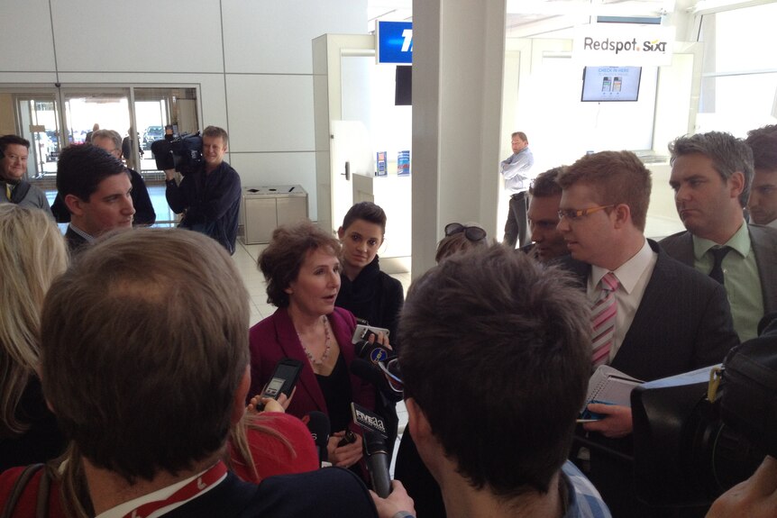 SA Opposition Leader Isobel Redmond surrounded by reporters at Adelaide Airport responding to speculation, August 14 2012