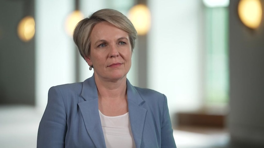 A woman in a suit looks to the side