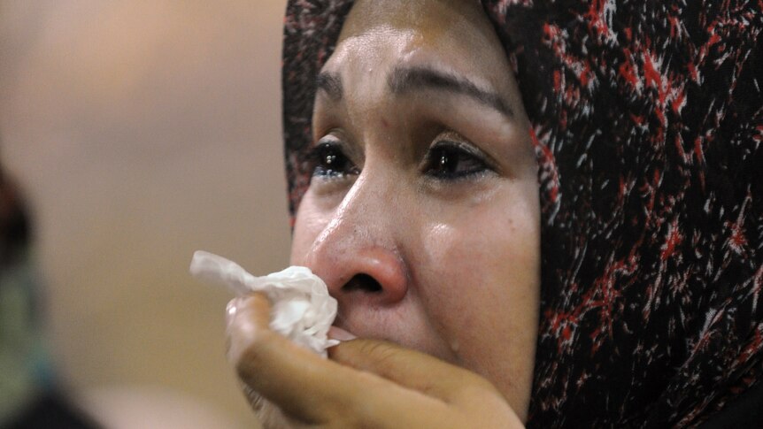 Woman mourns after Indonesia plane crash