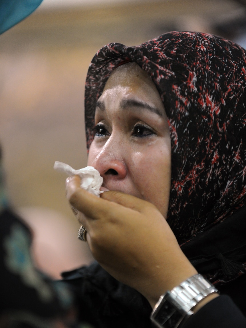 Woman mourns after Indonesia plane crash