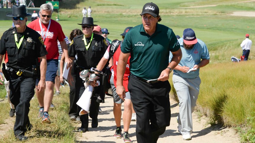 Phil Mickelson leaves the course after playing the third round of the U.S. Open at Shinnecock Hills.