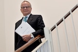 The chair of the Commission of Audit, Tony Shepherd, poses for photos during the lockup.