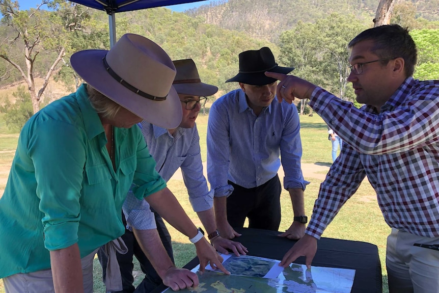 Four people looking at a map.