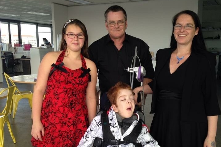 Michelle Piefke with her daughter Sarah, her son Ryan in a wheelchair, and her partner Keith.