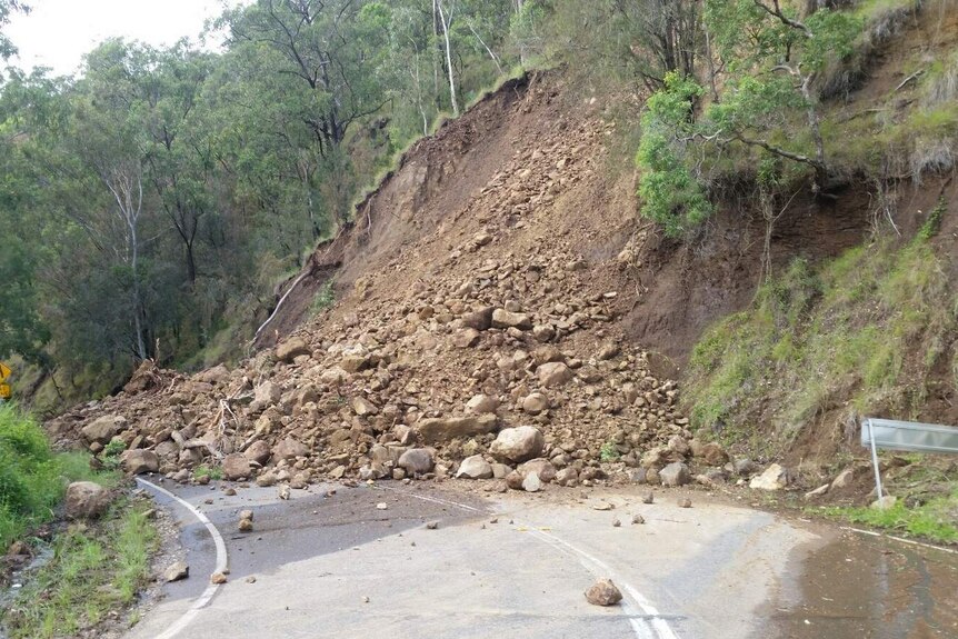 Rocks and dirt cover road after a landslide on Lamington National Park Road. March 31, 2017.