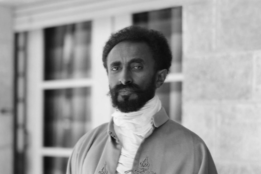 A beared Emperor Haile Selassie wears traditional attire in this portrait.