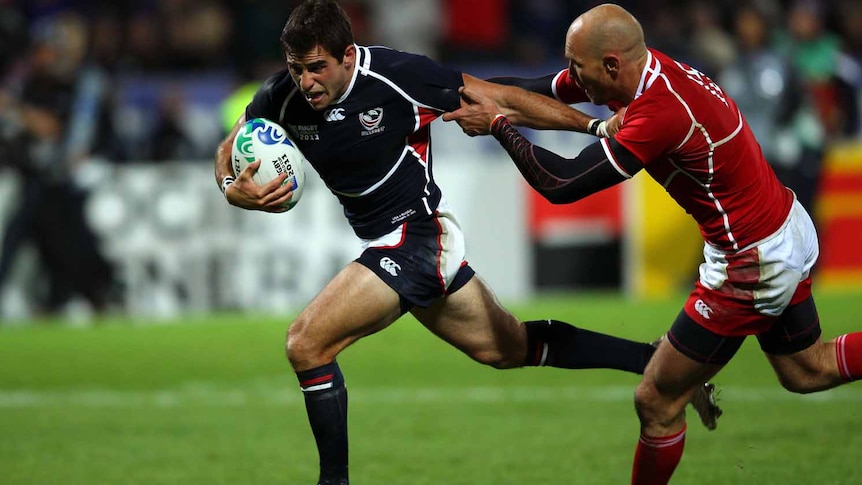 Mike Petri hands off Igor Klyuchnikov to score the match-winning try for USA.