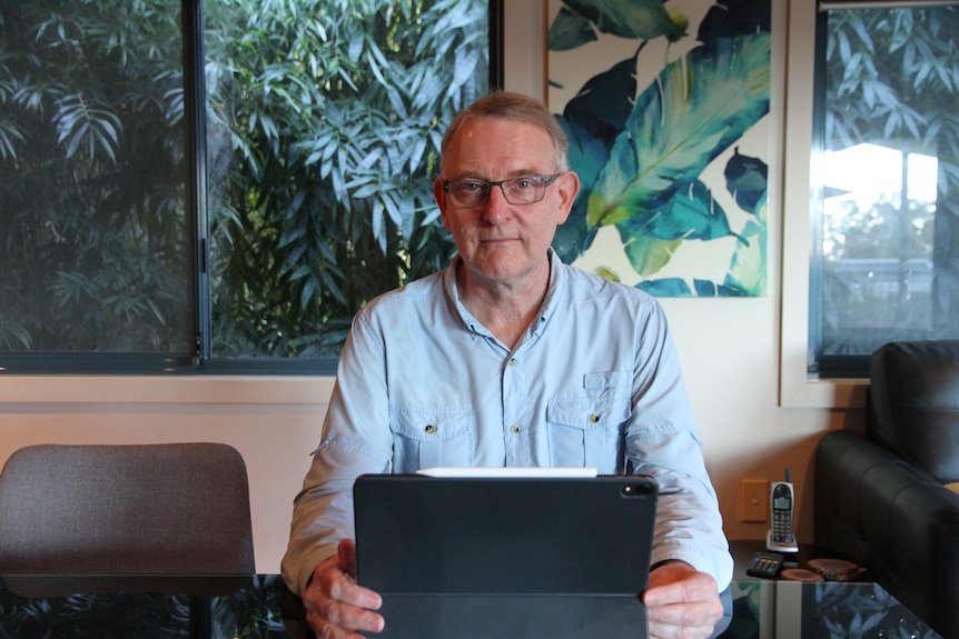 Martin North sits at a table 