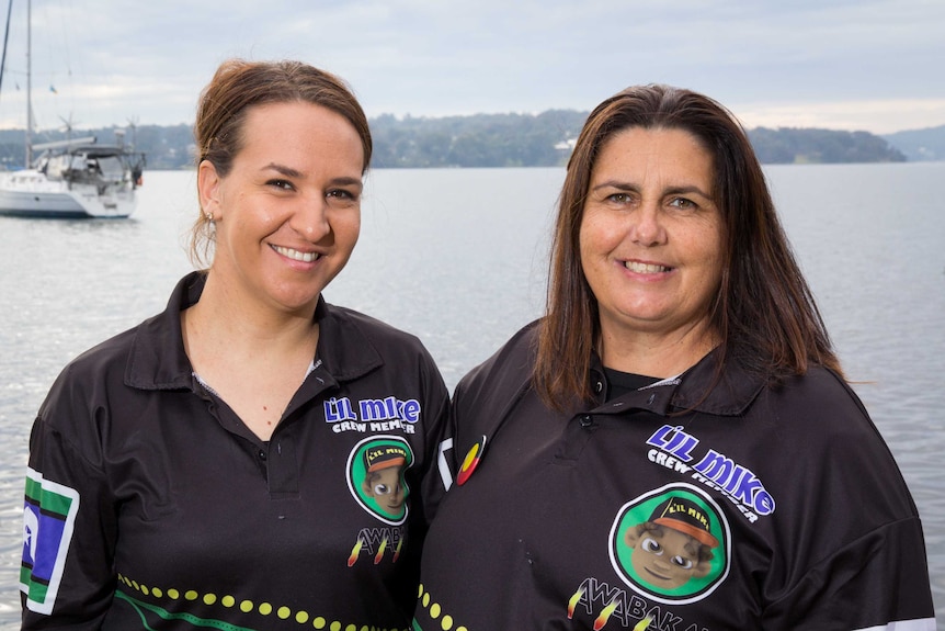 Kirra-Lee Briggs and Julie Rose stand next to Lake Macquarie.