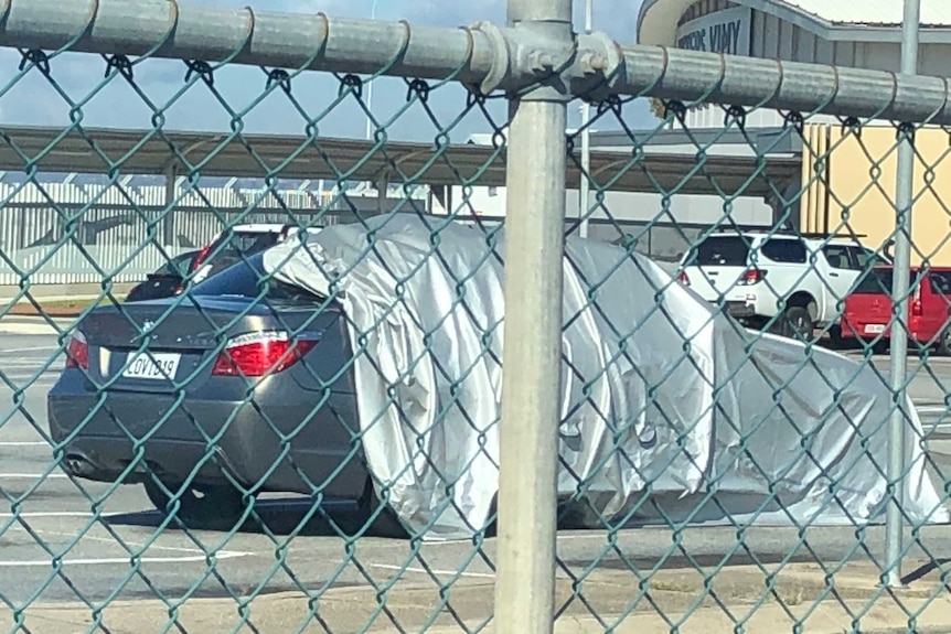 A car at Adelaide Airport carpark with the number plate "COVID 19".