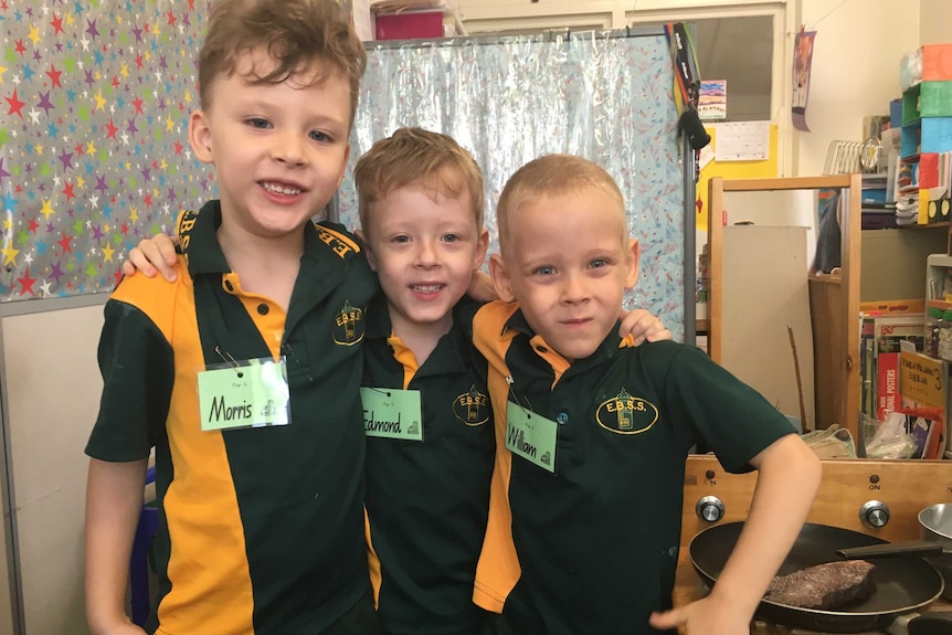 Triplets Morris, Edmond and William in their school uniforms.