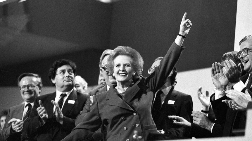 A black and white photo of Margaret Thatcher celebrating her electoral victory in 1987