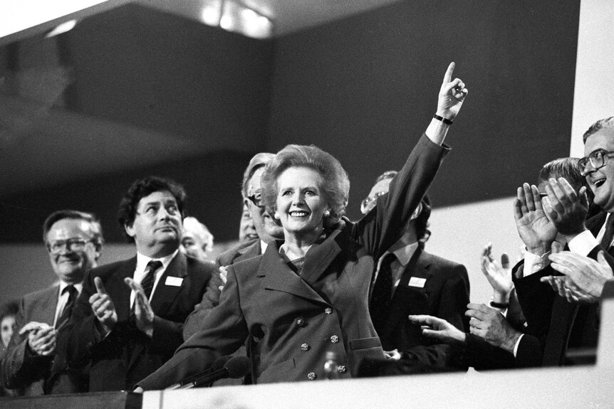A black and white photo of Margaret Thatcher celebrating her electoral victory in 1987