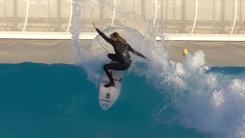 Ellie Lambkin surfing in a wave pool 